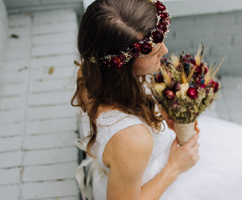 A bride holding flowers made by a wedding planner