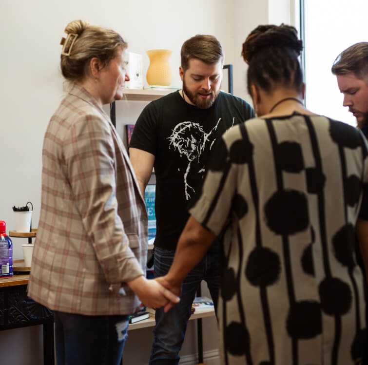 A prayer group meeting at a church emphasizing the need for website design for churches